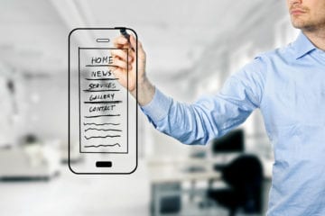 Designer drawing mobile website development wireframe