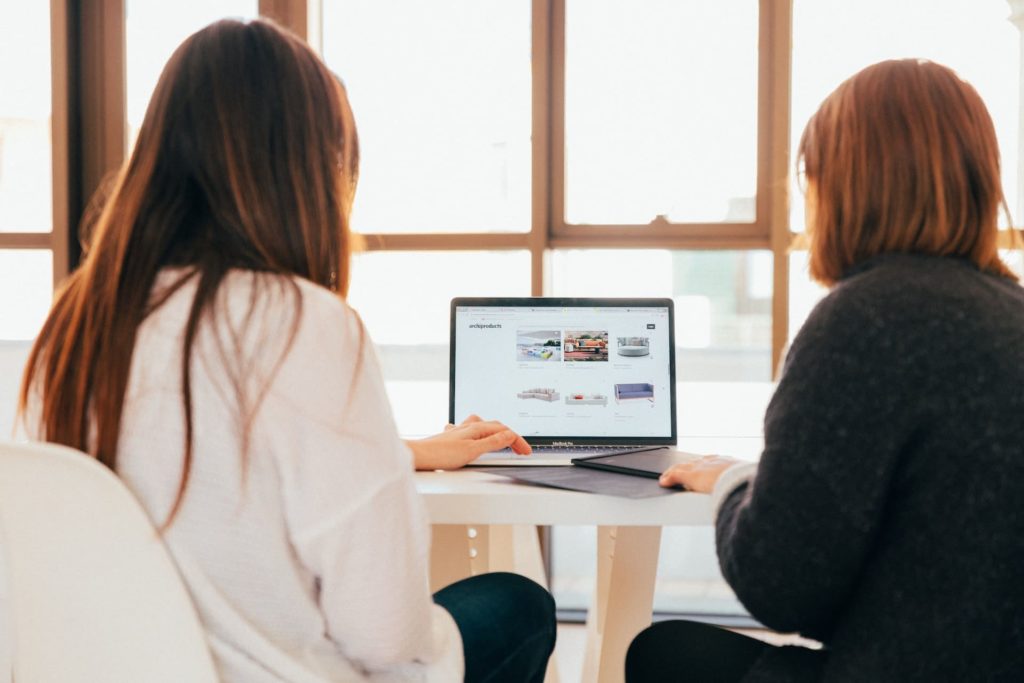 two women looking on website