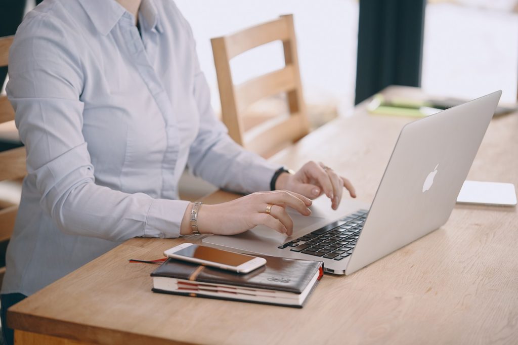 woman typing on laptop