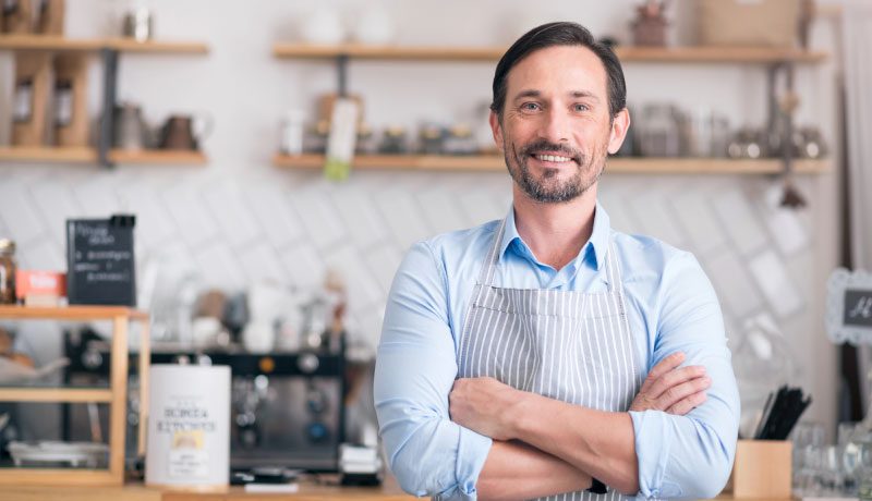 man in his place of work smiling